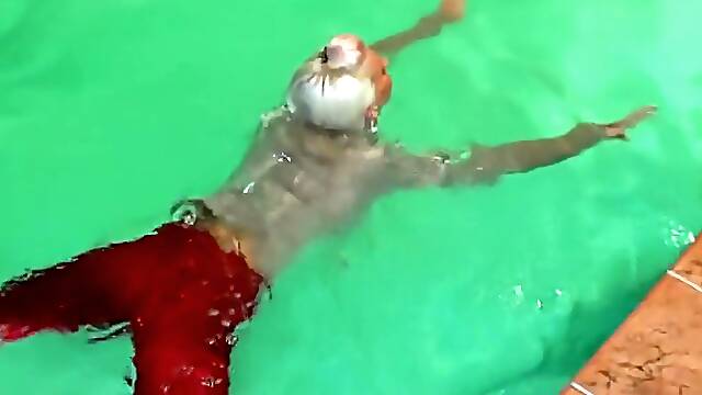 German wetlook with fully clothes swimming