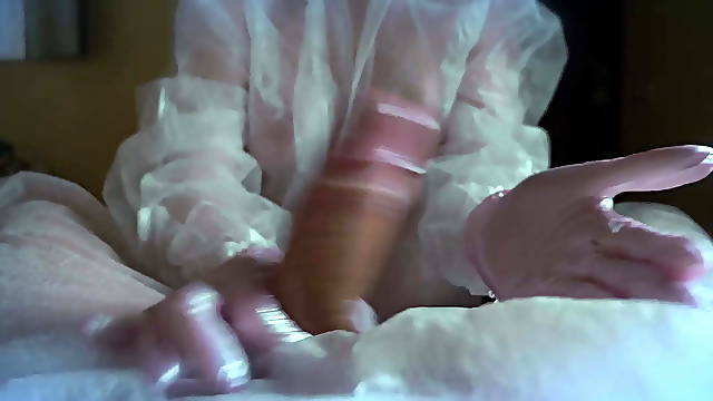 WOMAN IN A GAS MASK AND GLOVES JERKS OFF A COCK AND SUCKS. H