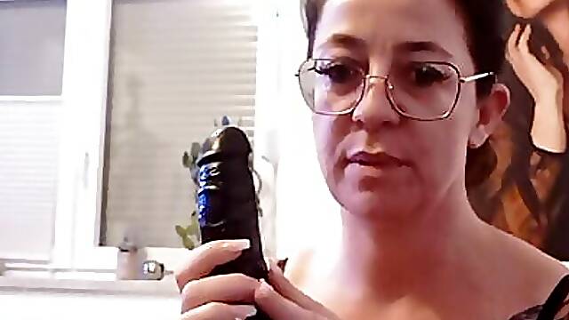 Tattooed brunette with glasses plays with her tampoo