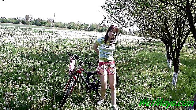 Peeing on her bicycle